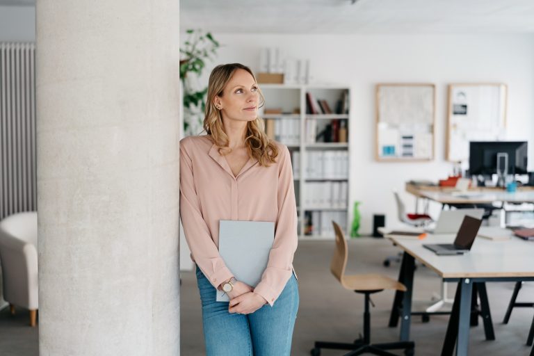 Business Woman Leaning On Pillar