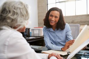 Smiling accountant in consultation with senior woman